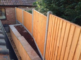 After - closeboard panels on concrete posts